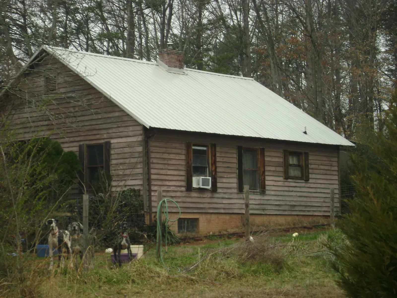 White metal roof on an old wood sided farmhouse, from a Metal Roof Installation job in Bergen